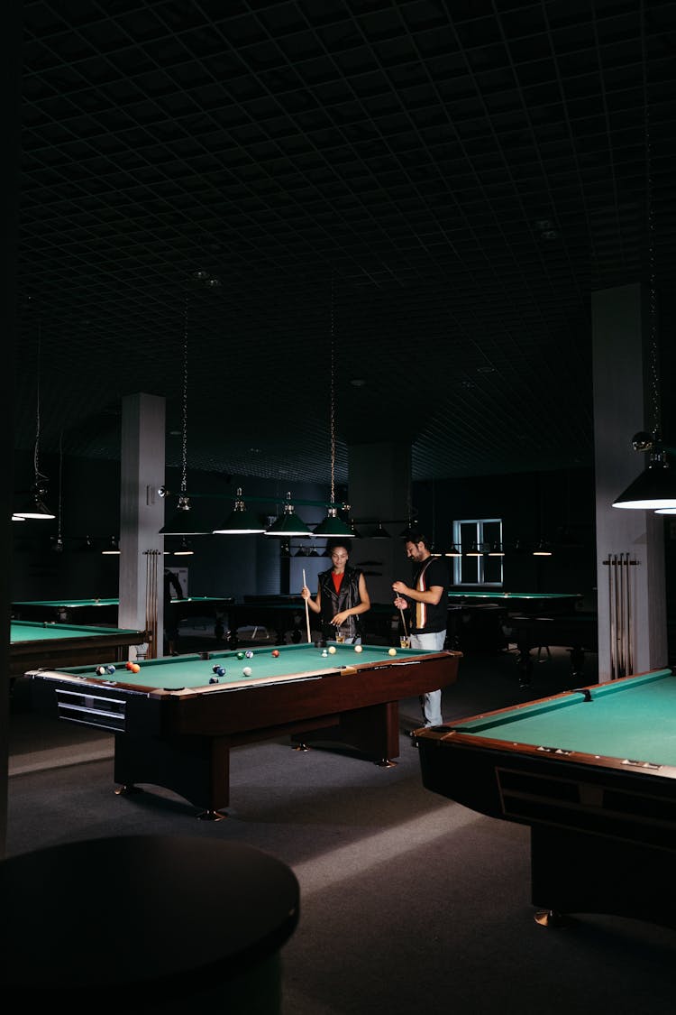 Man And Woman Playing Billiards