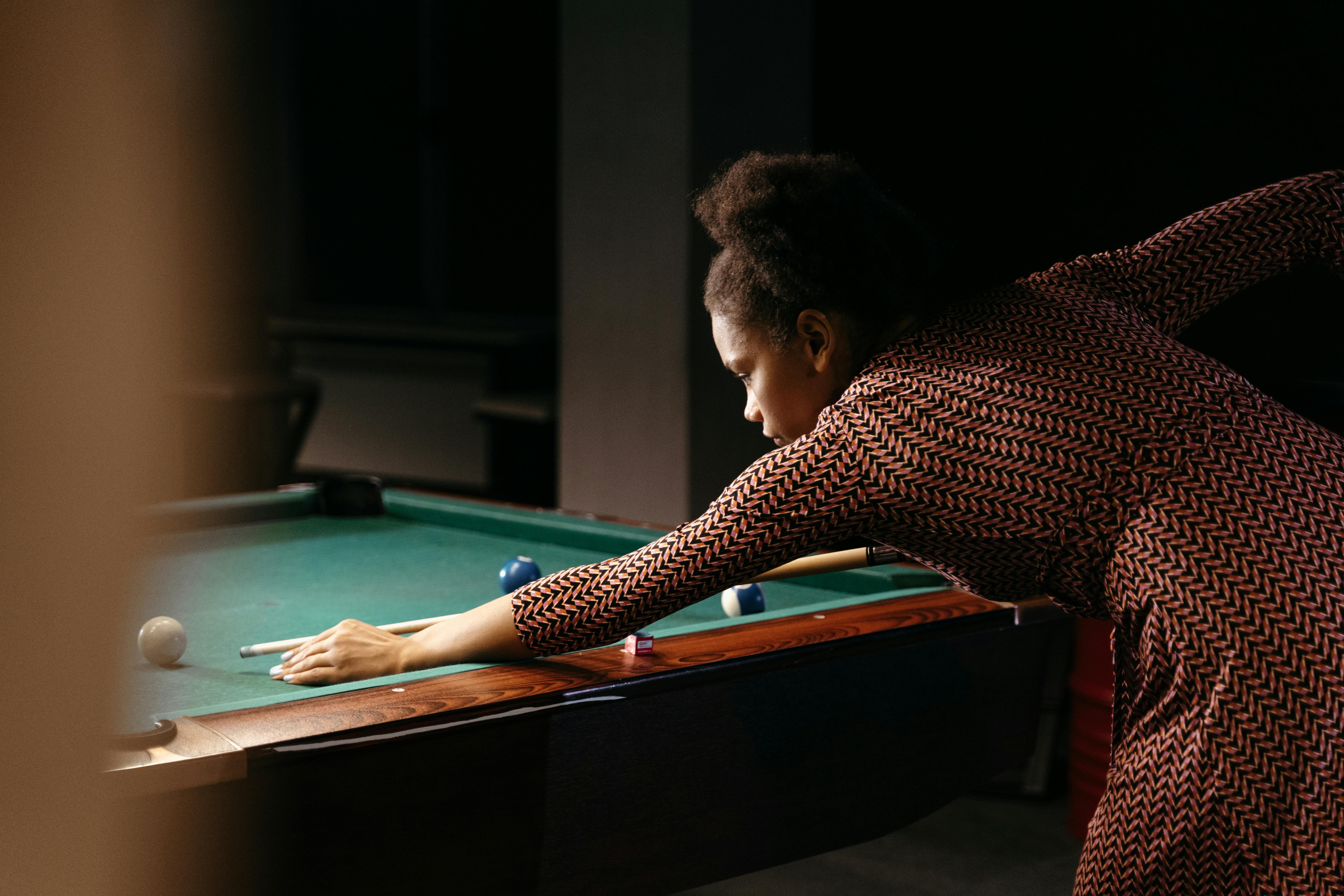 photo of a woman playing billiards