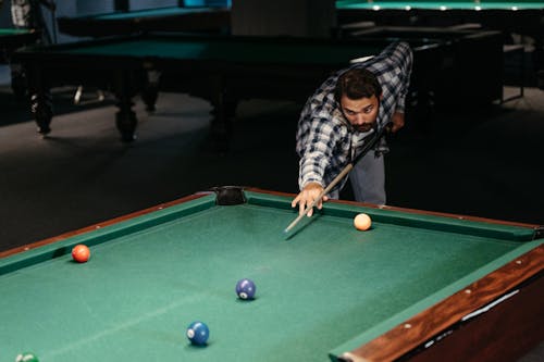 Free Man in Checkered Long Sleeve Shirt Playing Billiards Stock Photo
