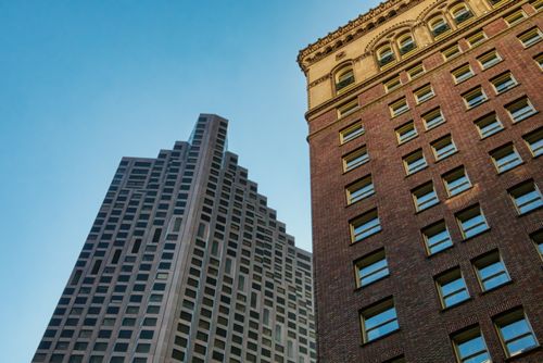 Free Low-angle view of San Francisco skyscrapers showcasing architectural styles against a clear blue sky. Stock Photo