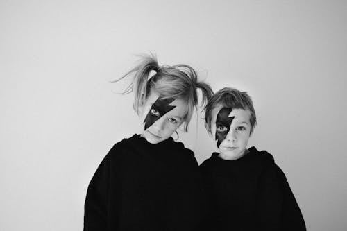 Grayscale Photo of Children with Face Paint