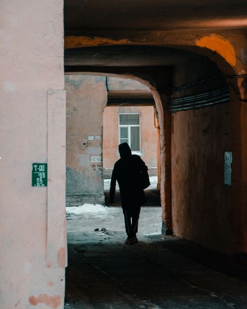 Free A silhouette of a person in a winter alleyway in Saint Petersburg, Russia. Stock Photo