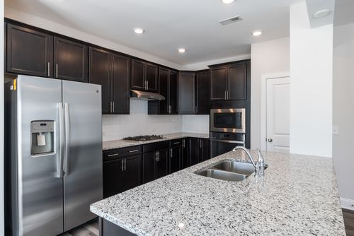 Free Sleek kitchen design featuring granite countertops and stainless steel appliances. Stock Photo