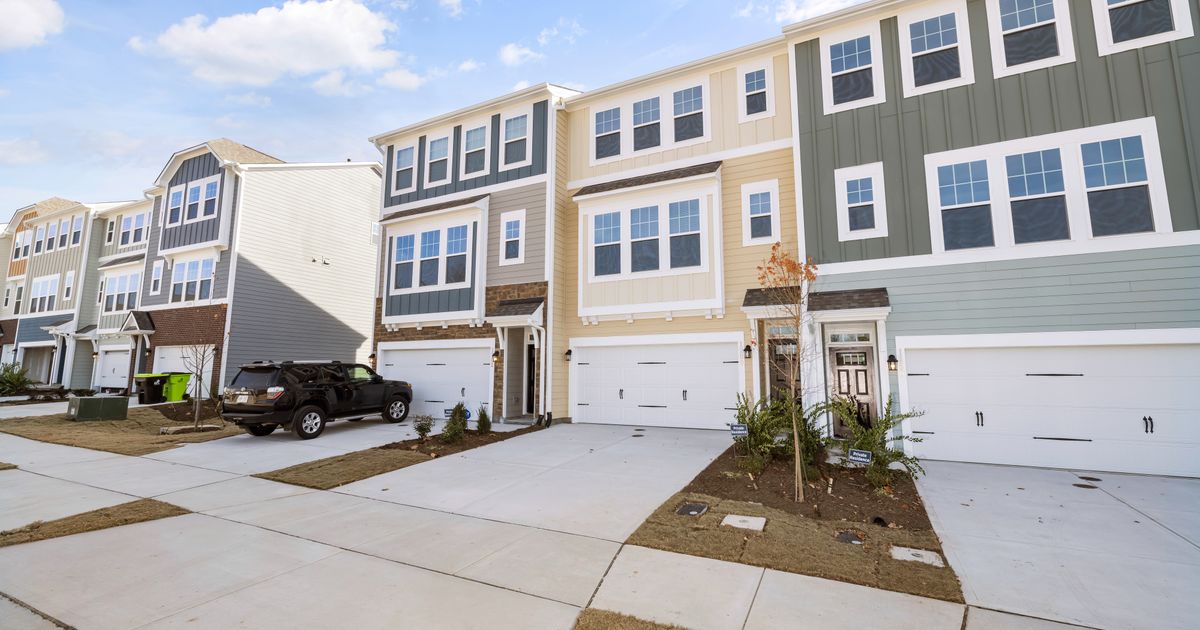 A row of modern suburban Maryland-style townhouses on a sunny day