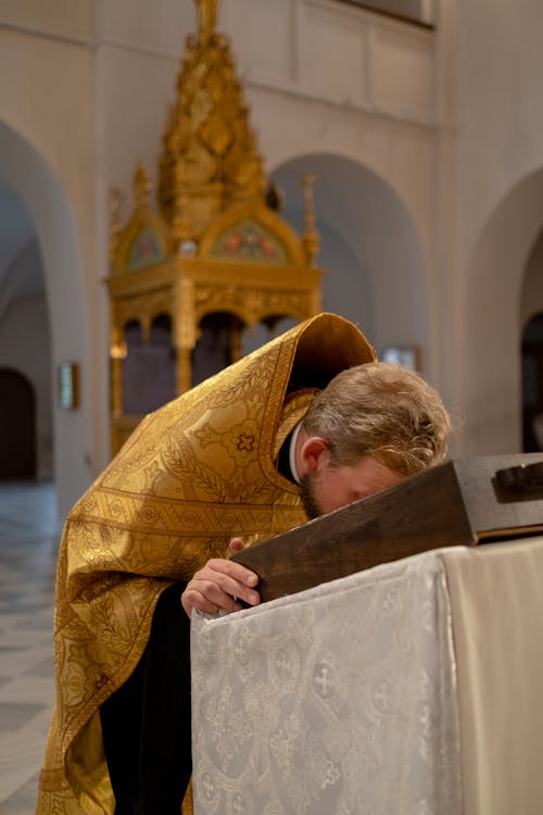 Priest kissing the Bible