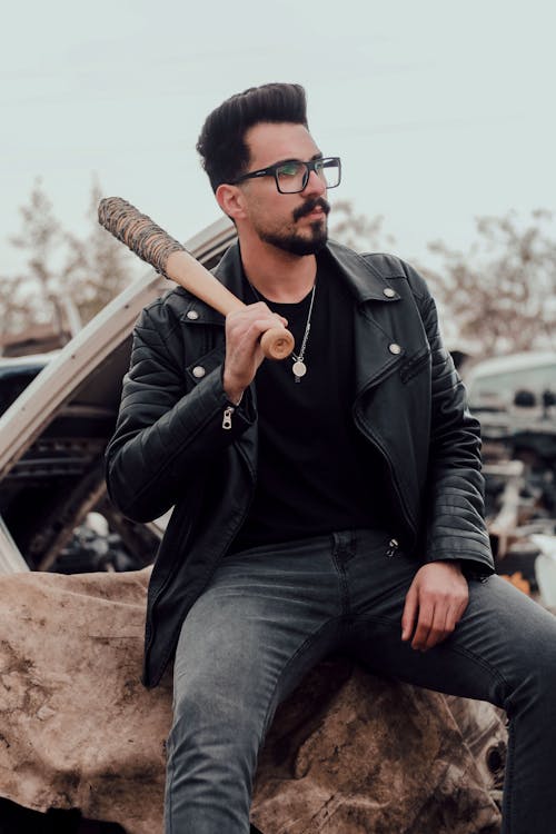 Man in Black Leather Jacket holding a Baseball Bat 