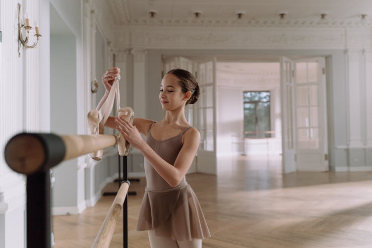 Smiling Girl Holding A Pointe Shoes 