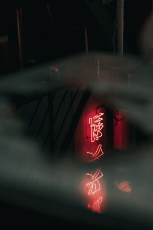 Free Moody neon sign reflecting in a dark during nighttime. Stock Photo