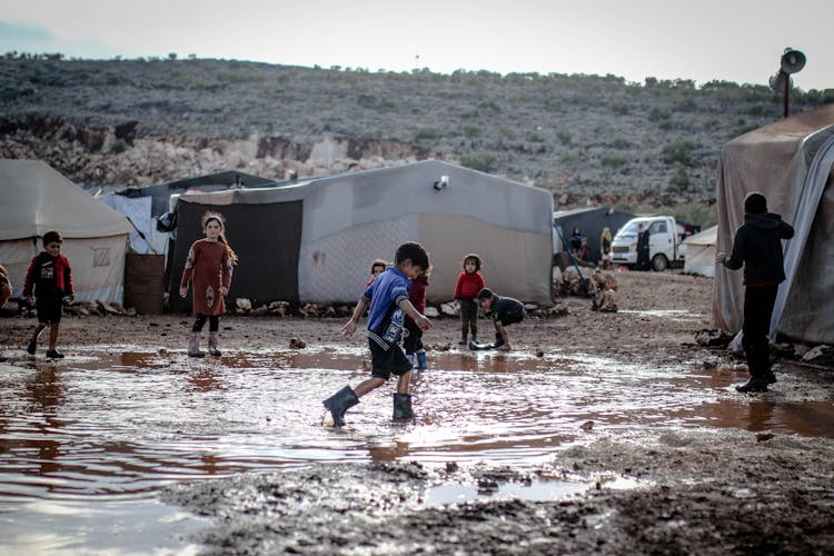 Kids Standing In Mud