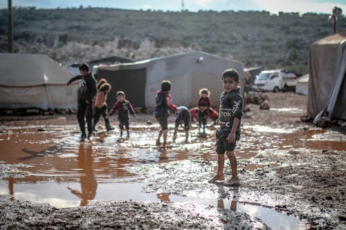 Kids Splashing Water in Puddle