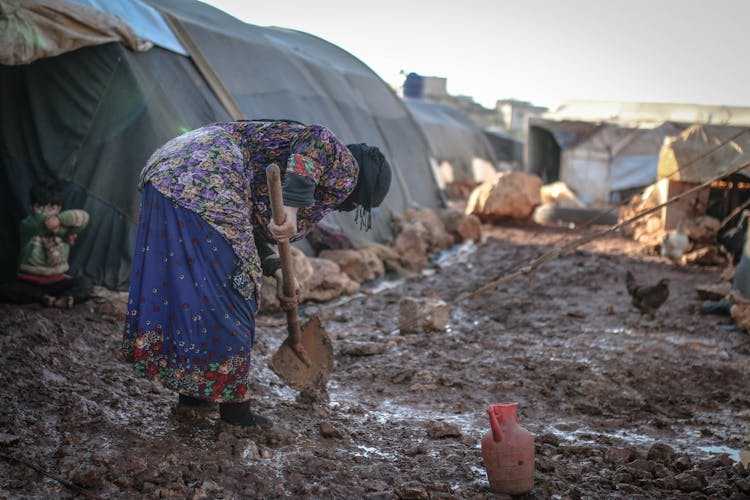 Elderly Woman Holding Shovel