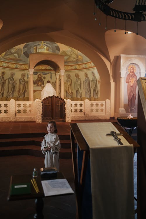Free Boy in Religious Dress Standing in Orthodox Church Stock Photo