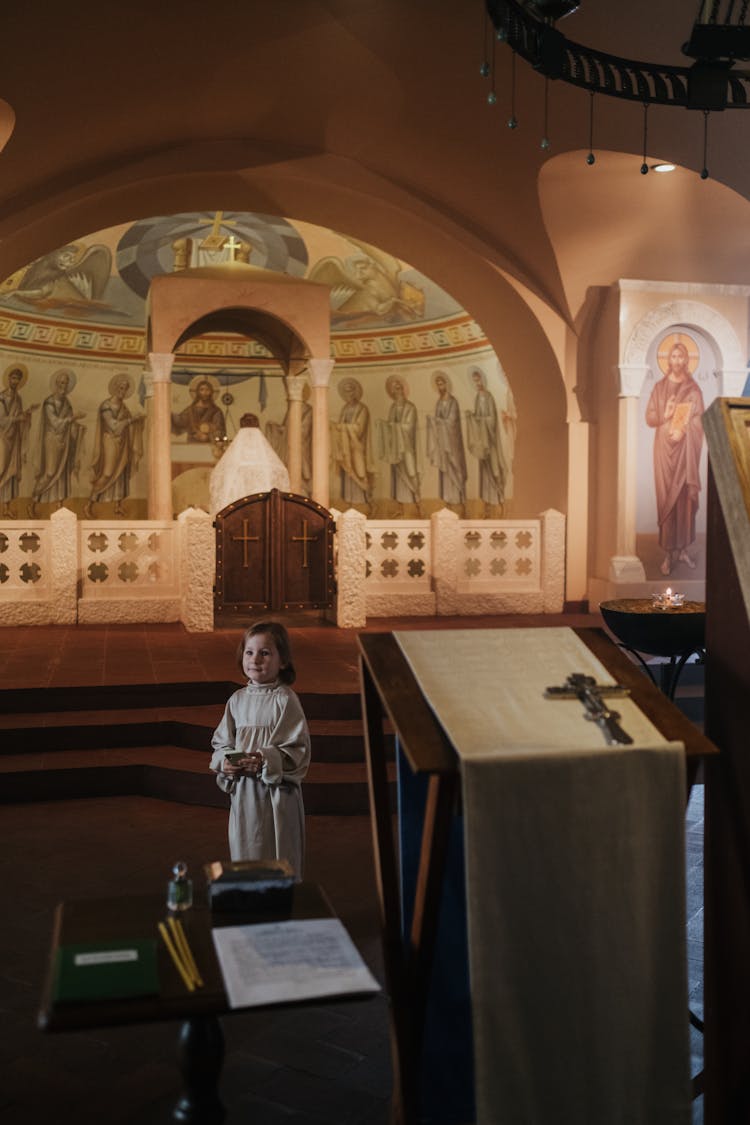 Boy In Religious Dress Standing In Orthodox Church