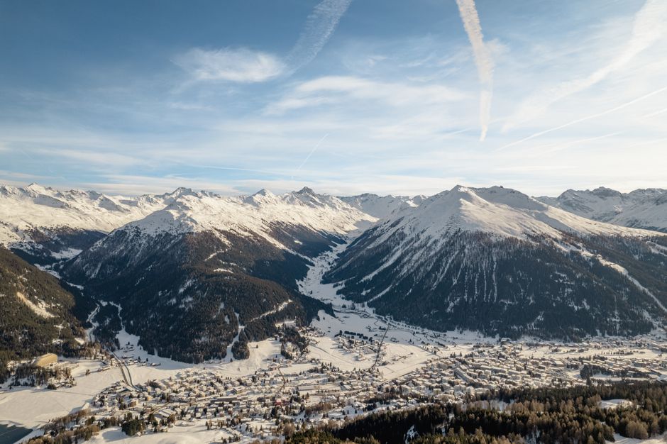 A breathtaking winter view of snow-covered mountains and village in Klosters-Serneus, Switzerland.