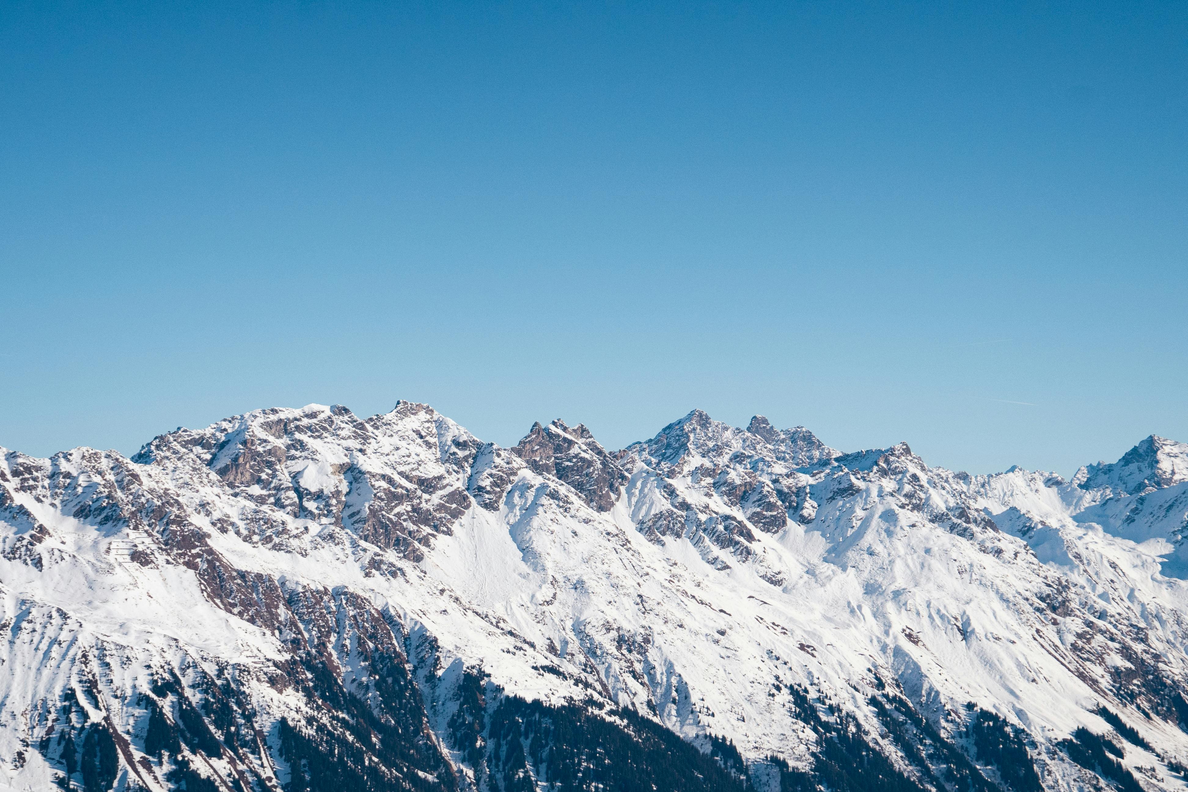 Prescription Goggle Inserts - Breathtaking view of the snow-covered Swiss Alps against a clear blue sky in Klosters-Serneus, Switzerland.