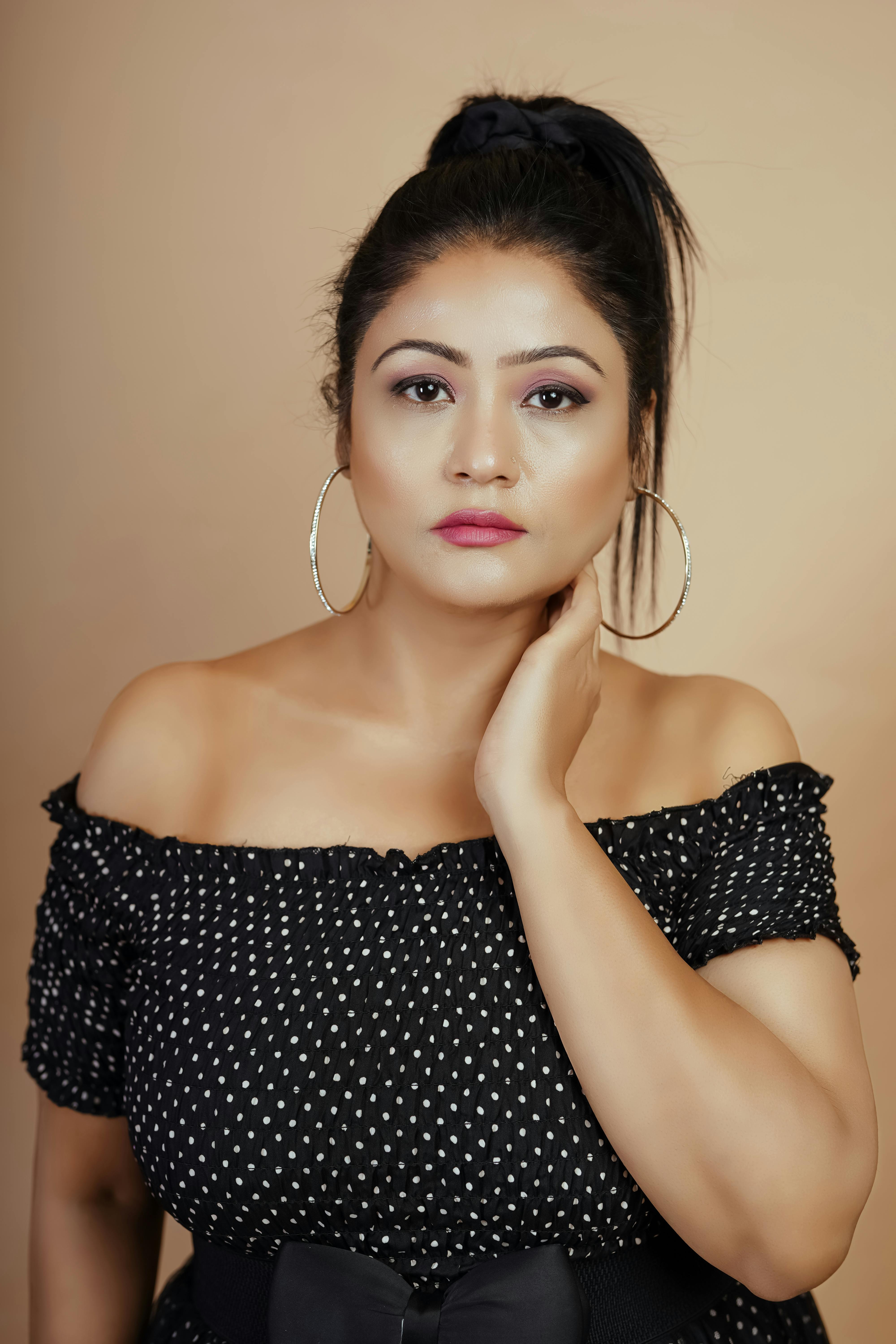 Beautiful portrait of an adult woman with a serious expression and elegant attire.