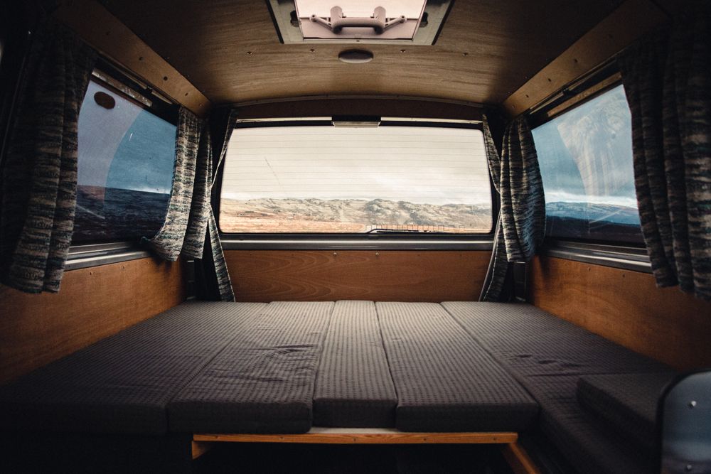 Convertible berth folded flat beneath a panoramic rear window — photo by Erik Schereder on Pexels