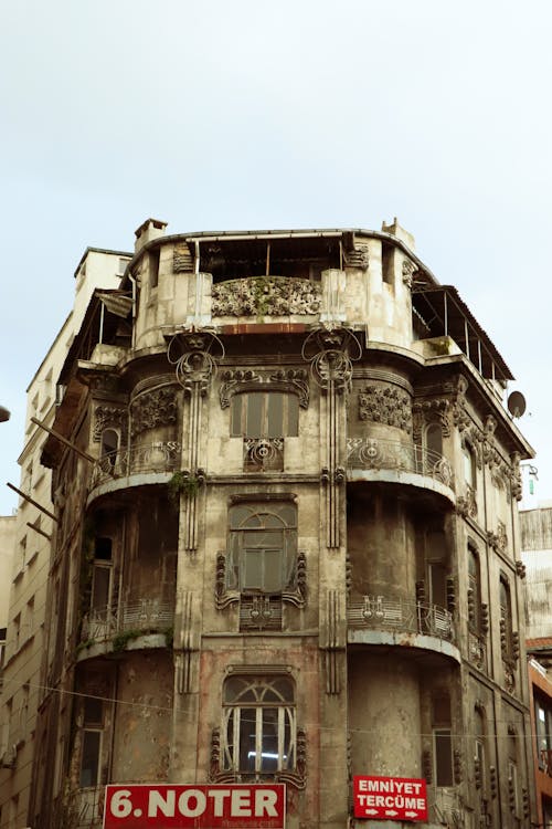 Brown Building with Glass Windows Under White Sky