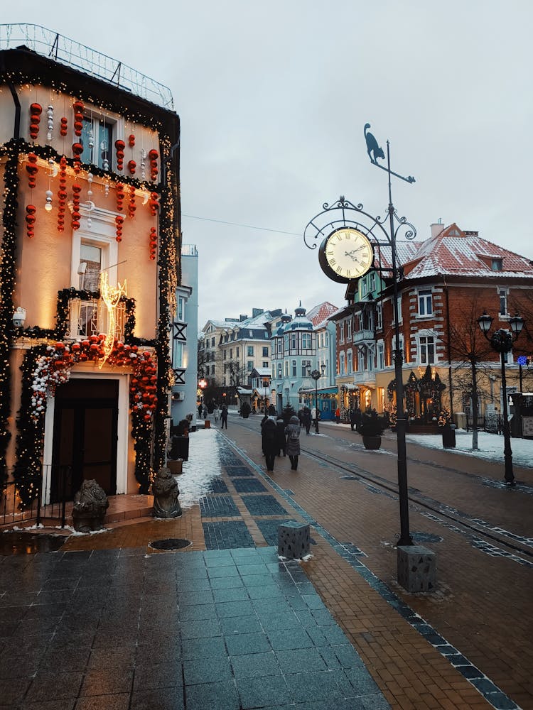 People Walking On Street With Christmas Decorations