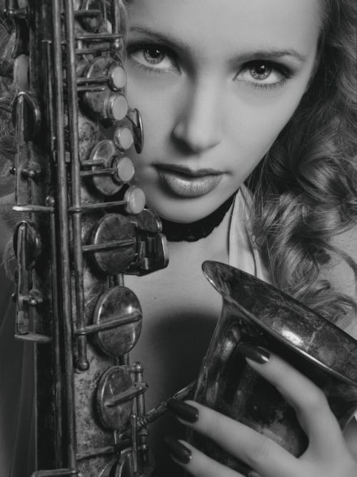 Free Grayscale Photo of a Woman Holding Saxophone Stock Photo