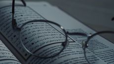 Black Framed Eyeglasses on White Printer Paper