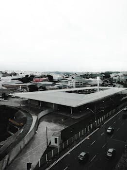 High-angle view of a modern urban cityscape showing streets, buildings, and light traffic.