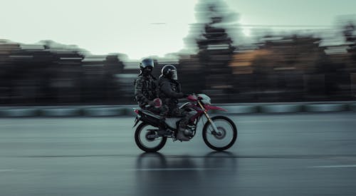 Two Persons Riding a Motorcycle