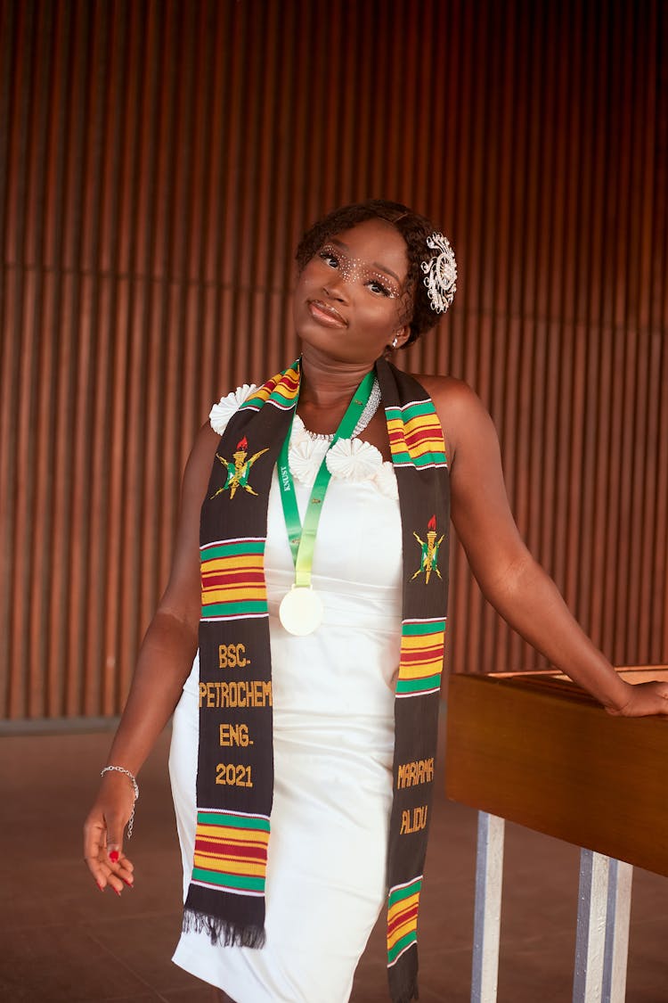 Woman In White Dress And Colorful Graduation Stole