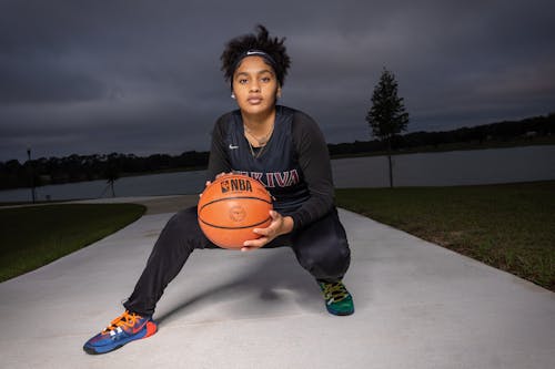 Woman Holding a Basketball