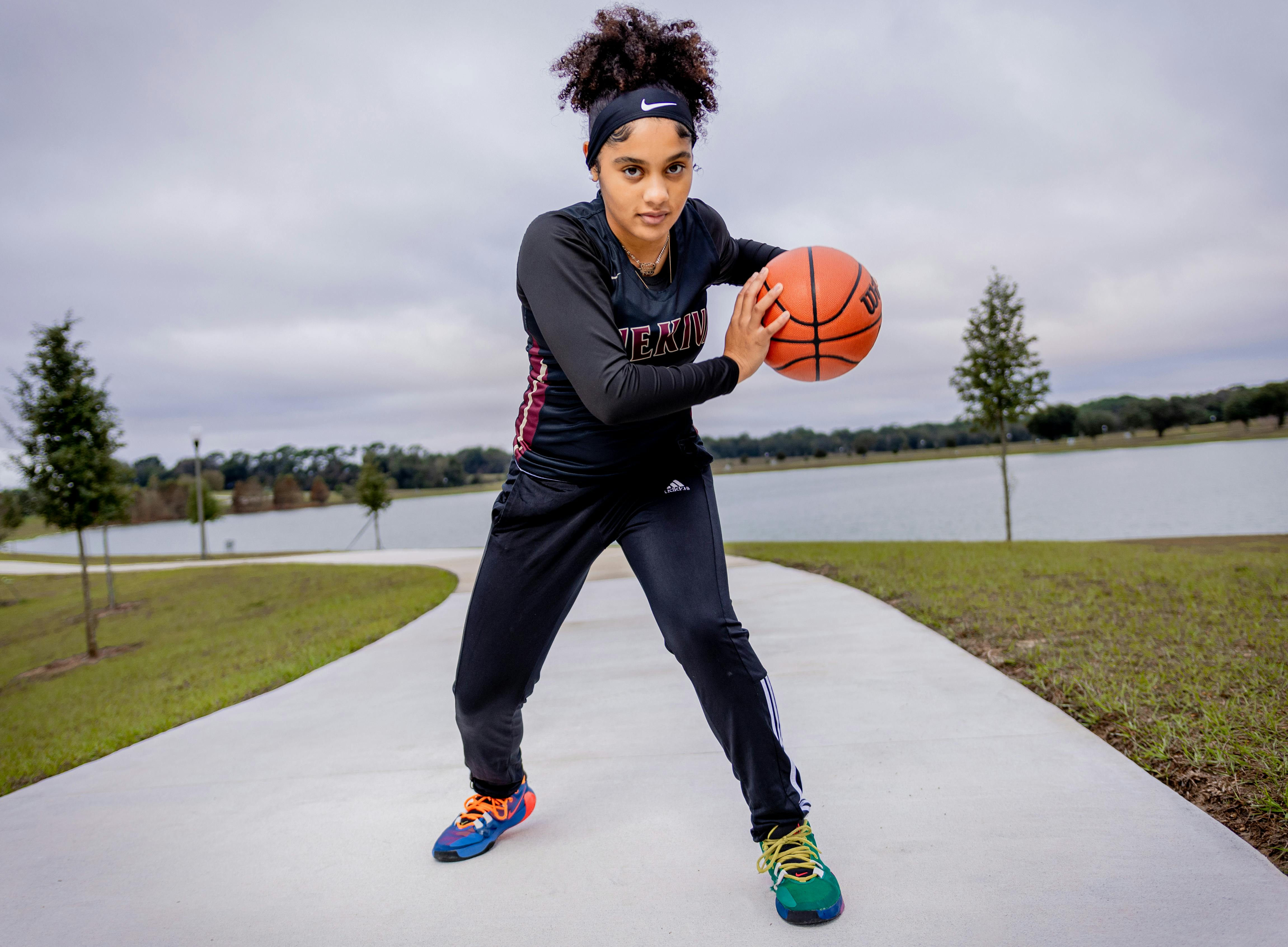 dental and vision insurance plans Florida - A young black woman in athletic gear poses with a basketball outdoors, showcasing active lifestyle and sport activity.