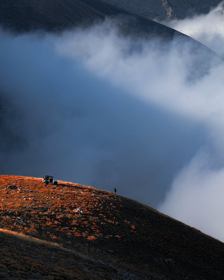 Man Standing On A Mountaintop