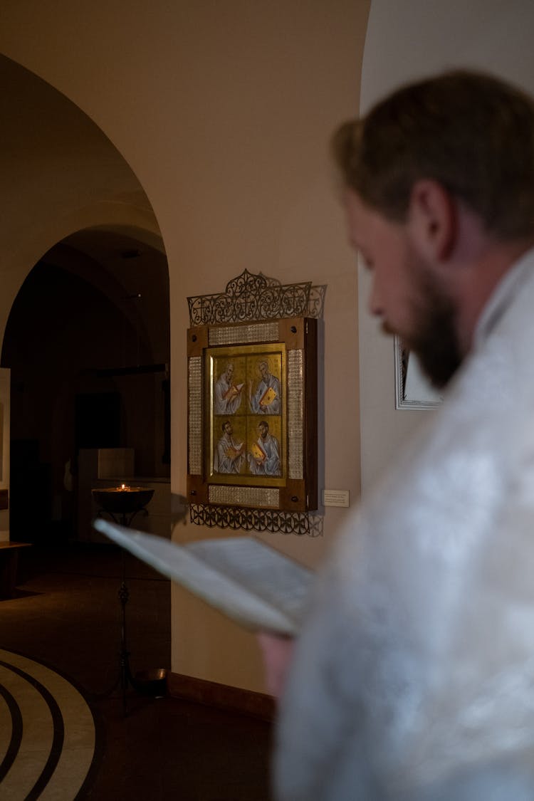 A Bishop Speaking While Holding A Bible