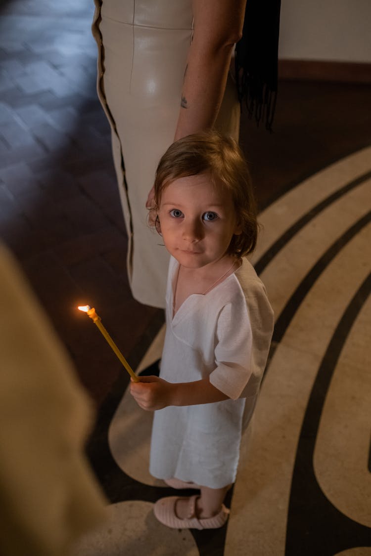 Girl In White Dress Holding A Candle