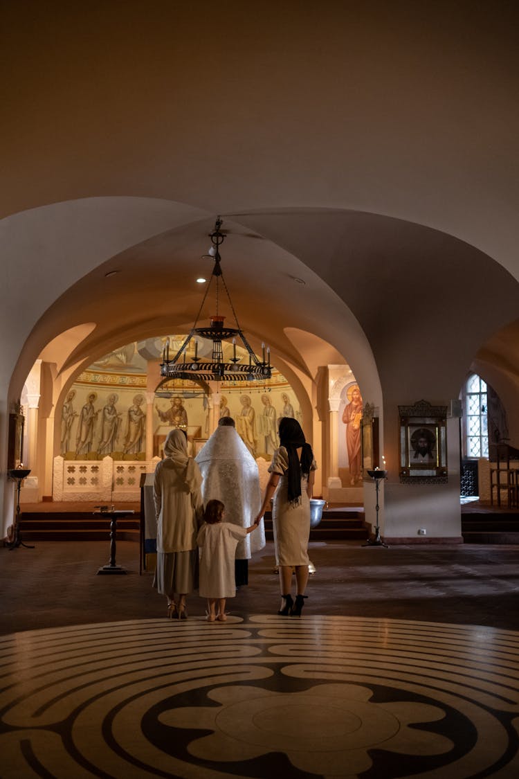 Worshippers Attending Baptism Ceremony In Orthodox Church