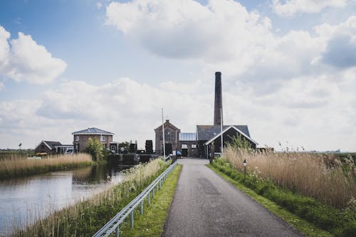 Clouds over Buildings with Chimney and River