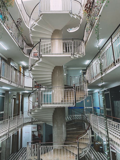 White Concrete Spiral Staircase with Metal Railings 