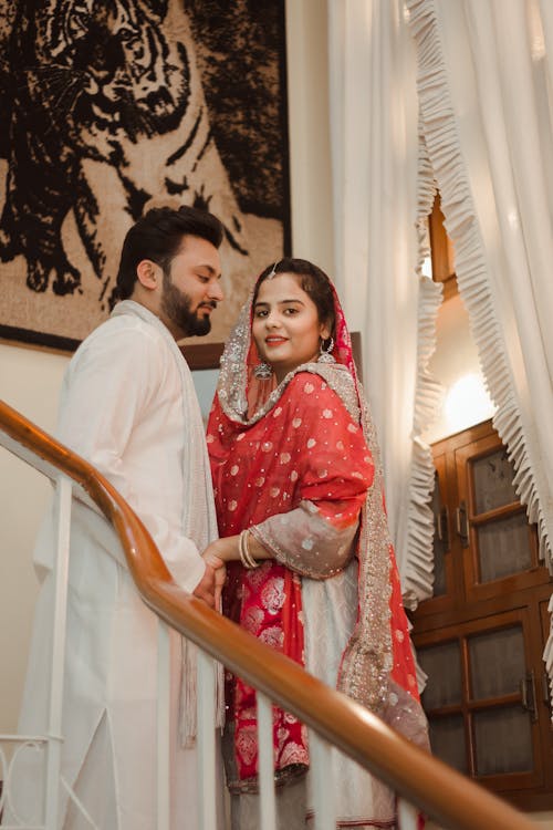 Sweet Couple Standing near the Wooden Handrails 