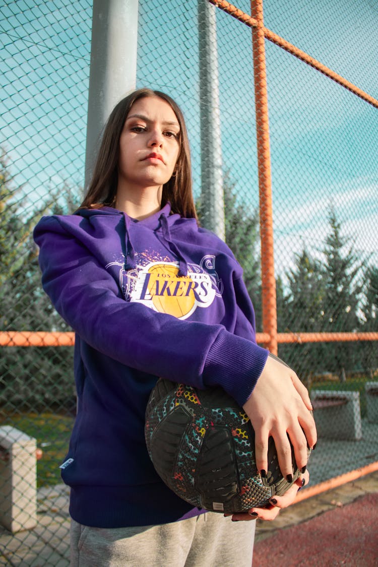 Portrait Of Woman In Sweatshirt Holding Basketball