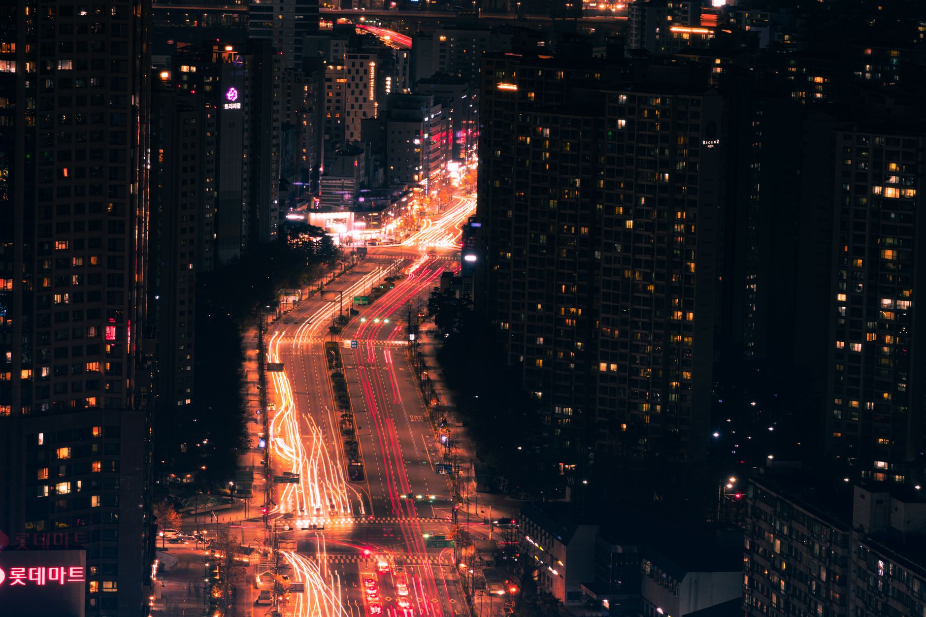 A stunning aerial view of city lights and traffic light trails capturing the dynamic essence of urban nightlife.