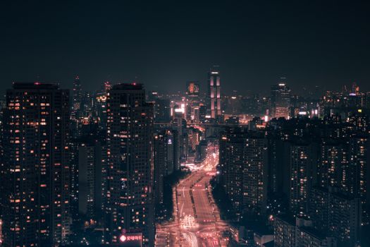 Captivating urban cityscape showcasing illuminated skyscrapers against a night sky.