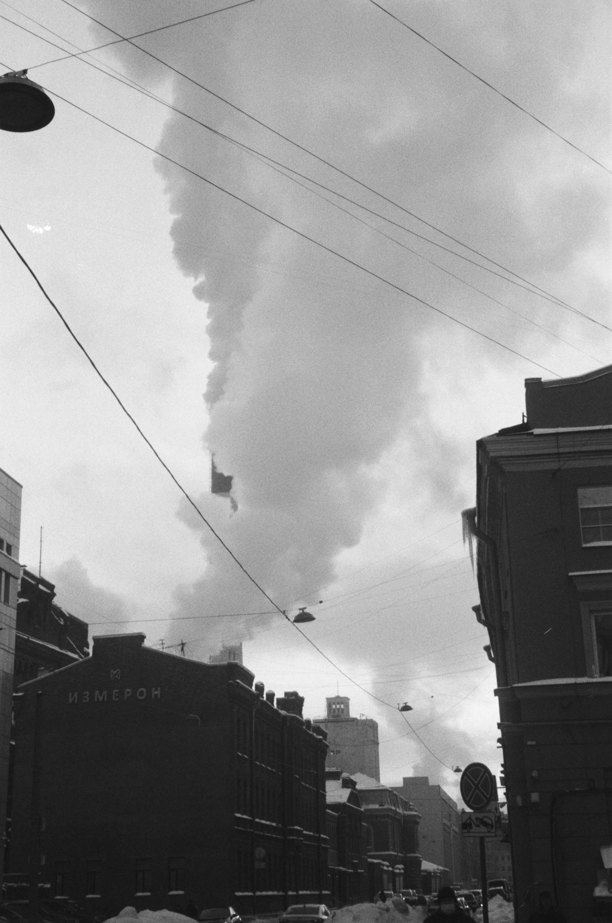 Black and white scene of city buildings and smoke in Saint Petersburg, Russia.