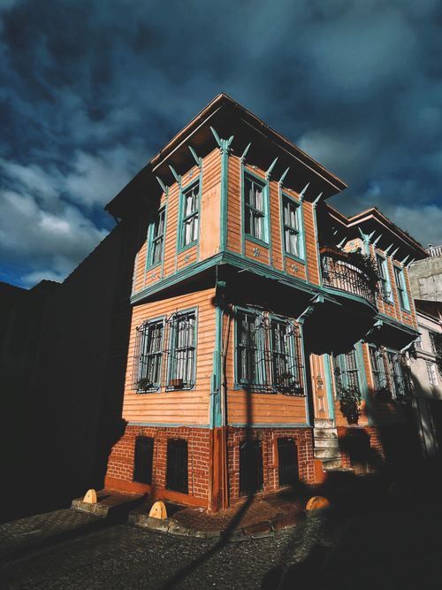 Free Beautiful historic wooden house in Turkey under a dramatic cloudy sky, showcasing architectural charm. Stock Photo