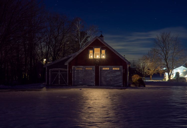 A Wooden House With Lights At Night