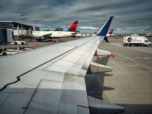 Free View of an Airplane Wing on an Airport Stock Photo