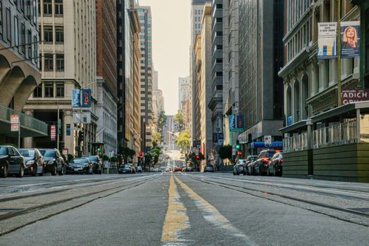 A bustling urban street view showcasing San Francisco's iconic cityscape with busy traffic and tall buildings.