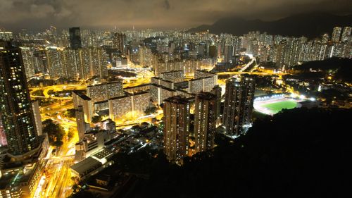 Free Stunning aerial view of Kowloon's illuminated skyline at night, showcasing urban high rises and city lights. Stock Photo