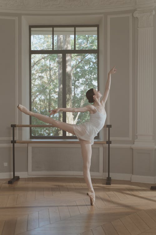 A Ballerina Dancing while Balancing Her Body Using on Leg
