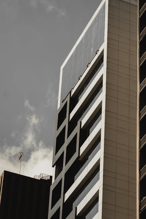 Building with Glass Windows Under Gray Sky