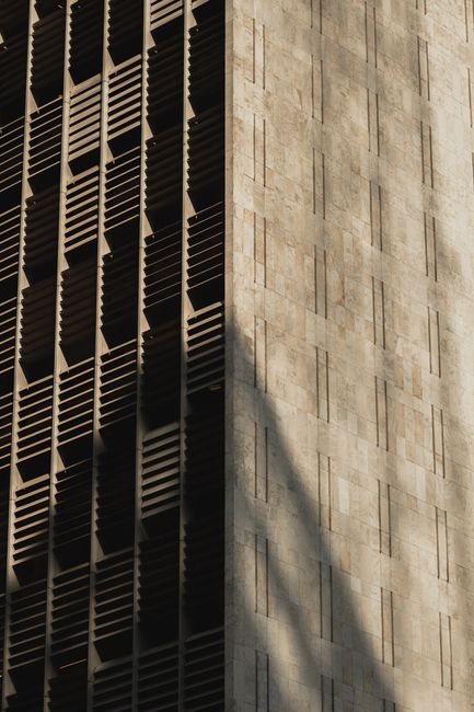 Close-up of a modern building facade highlighting shadows and textures. Perfect for urban architecture themes.