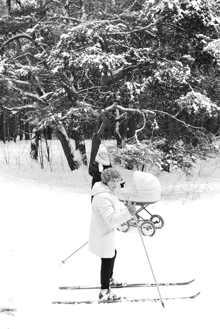 Grayscale Photo Of People Skiing Outdoors 